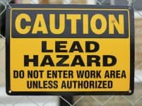 lead hazard caution sign on job site