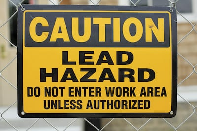lead hazard caution sign on job site
