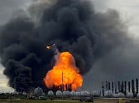 A process tower flies through air after exploding at the TPC Group Petrochemical Plant in Port Neches