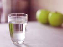 Glass of pure water on kitchen table