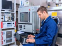 Young engineer working with a laptop working in a scientific lab