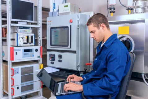 Young engineer working with a laptop working in a scientific lab