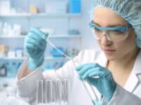 Young female tech or scientist performs protein assay