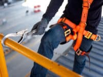 Construction Worker Use Safety Harness And Safety Line Working On A New Construction Site Project.