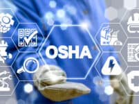 Industrial manager uses on a virtual screen of the future and sees the acronym: osha. osha occupational safety and health administration industry concept.