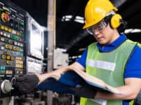 Asian,engineer,male,worker,maintaining,electronics,of,machine,at,the