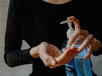 Hands using hand sanitizer