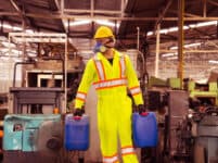 Industrial,worker,holding,plastic,bottle,with,chemicals,in,factory.worker,wearing