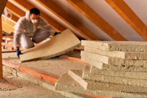 Man Laying Thermal Insulation