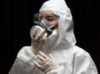 Woman,wearing,gloves,with,biohazard,chemical,protective,suit,and,mask.