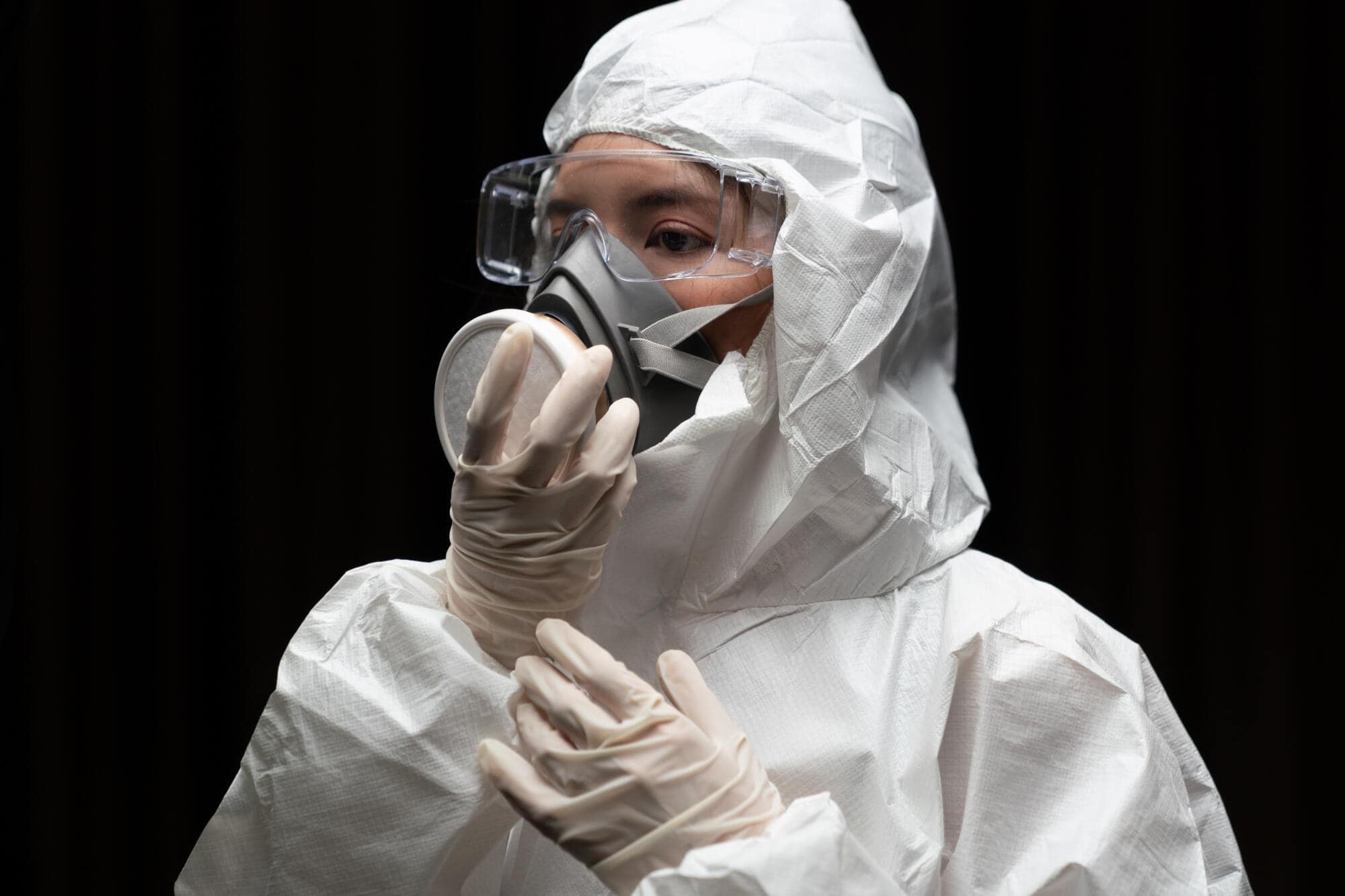 Woman,wearing,gloves,with,biohazard,chemical,protective,suit,and,mask.