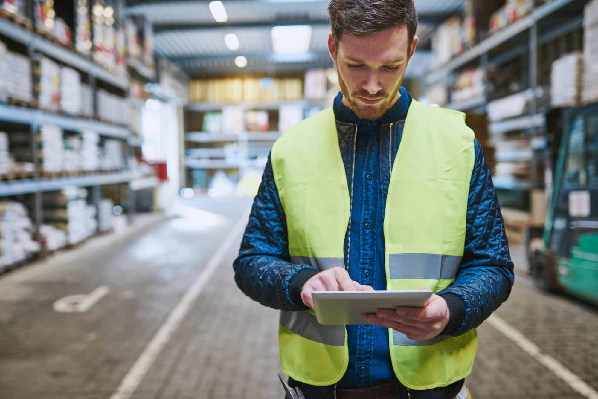 warehouse worker looking up safety information on phone