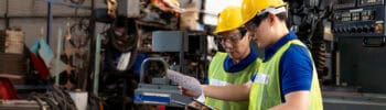 Factory,Male,Worker,Discussing,And,Looking,Clipboard,Document,For,Maintenance